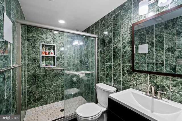 a bathroom with a toilet sink and mirror