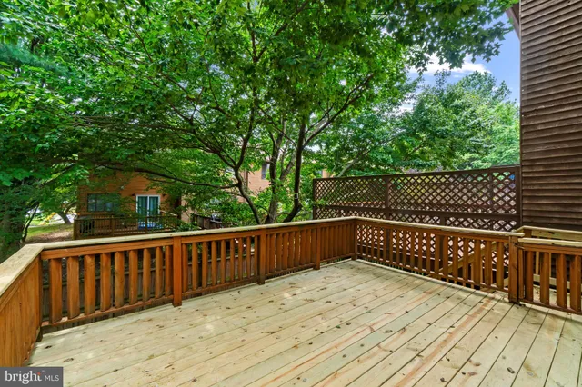 a terrace view with wooden floor and fence