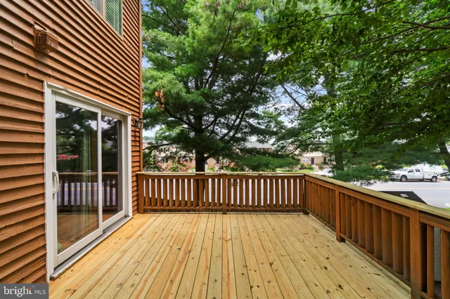 a view of balcony with wooden floor and fence