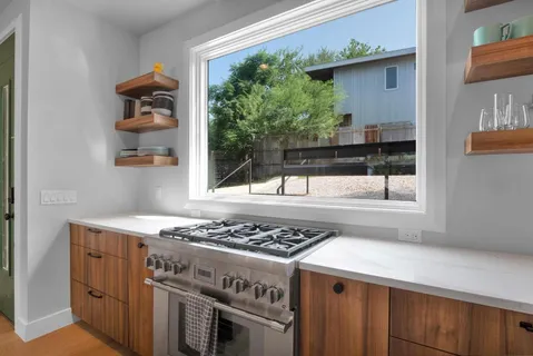 a kitchen with a stove and a window