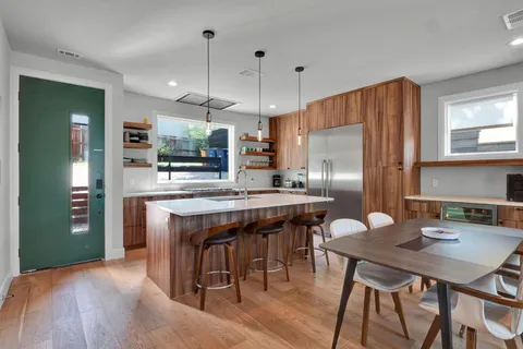 a kitchen that has a sink a stove and a refrigerator