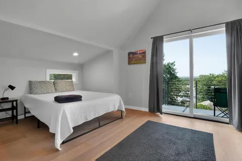 a bedroom with a bed and a window