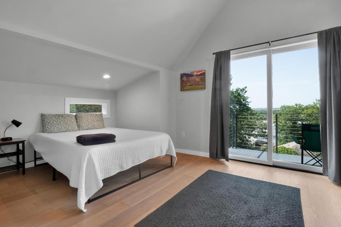 1914 East 8th Street Austin, TX 78702 - Photo 29 of 40 a bedroom with a bed and glass window