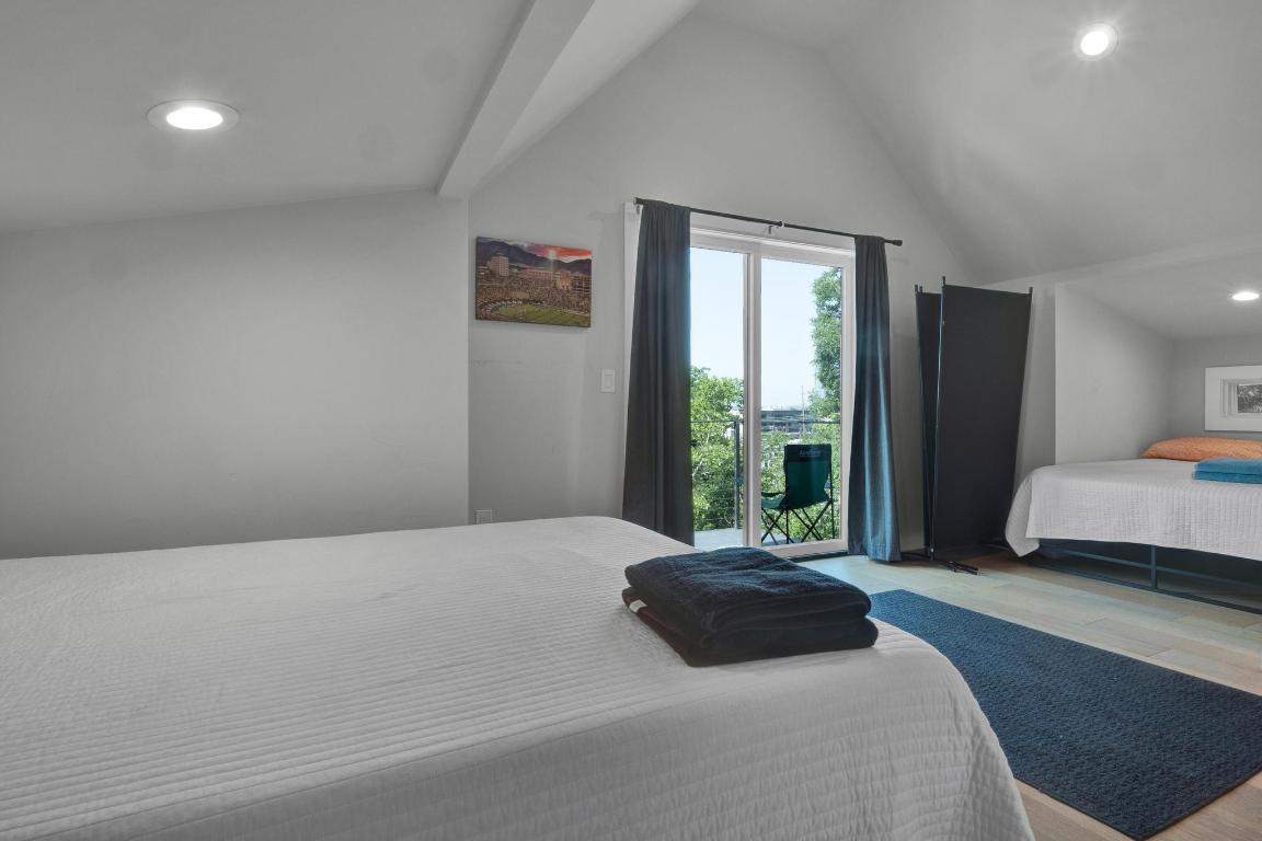 1914 East 8th Street Austin, TX 78702 - Photo 30 of 40 a bedroom with a large bed and a large window