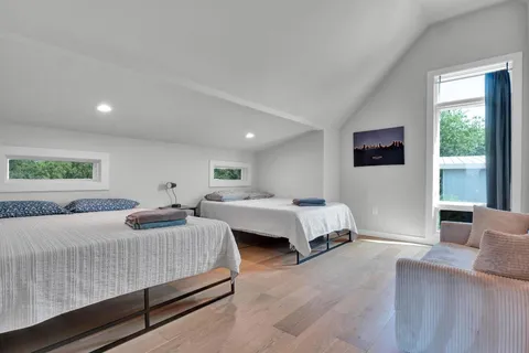 a bedroom with a large bed and a large window