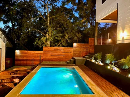 a backyard of a house with wooden floor and outdoor seating