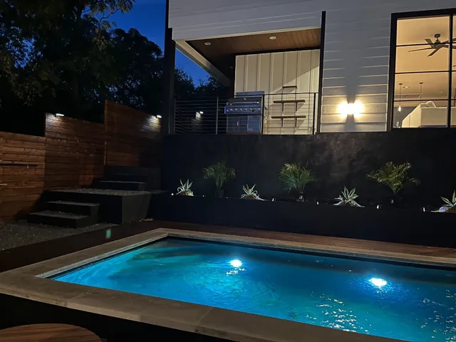 a room with pool table and chairs