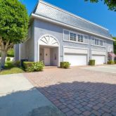 a front view of a house with a yard and a garage
