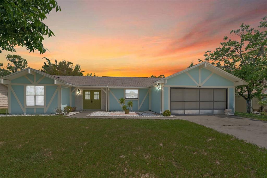 8351 Dunnellon Road Weeki Wachee, FL 34613 - Photo 1 of 1 a front view of a house with a yard and trees