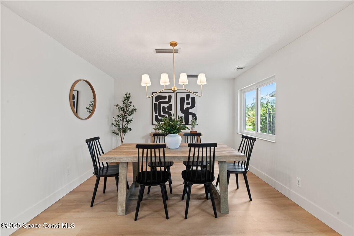 720 Wing Foot Lane Melbourne, FL 32940 - Photo 13 of 45 a view of a dining room with furniture and window