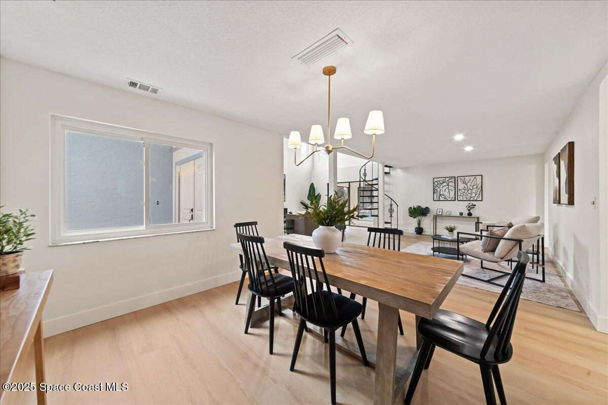 720 Wing Foot Lane Melbourne, FL 32940 - Photo 14 of 45 a view of a dining room with furniture and wooden floor
