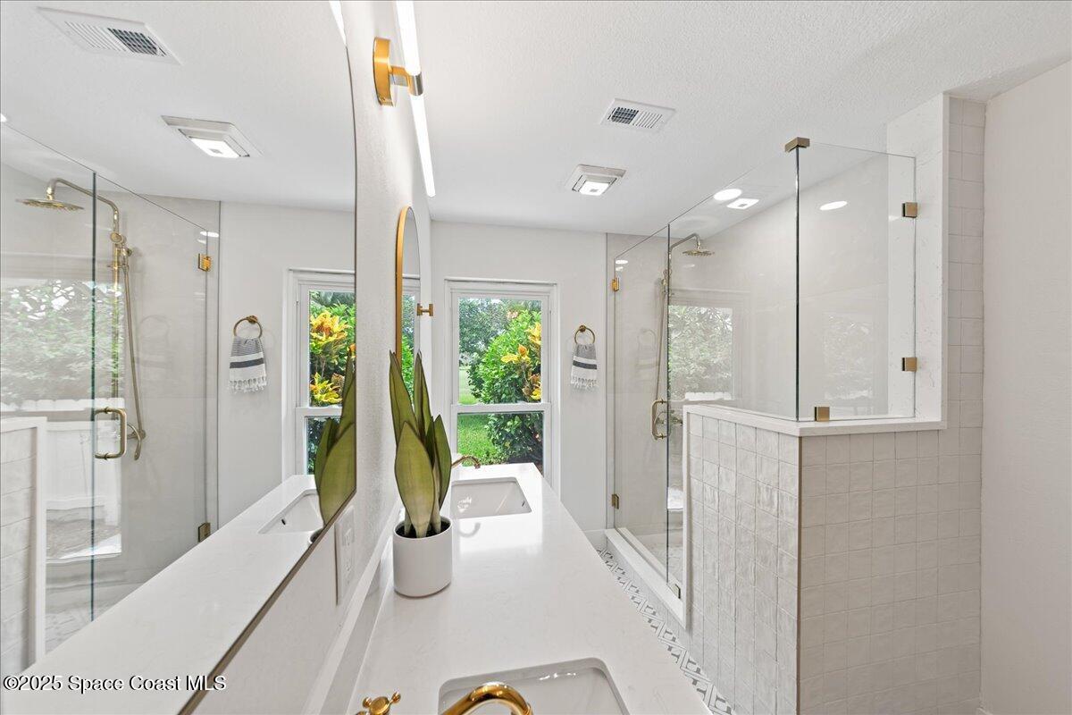 720 Wing Foot Lane Melbourne, FL 32940 - Photo 23 of 45 a bathroom with a tub shower and sink