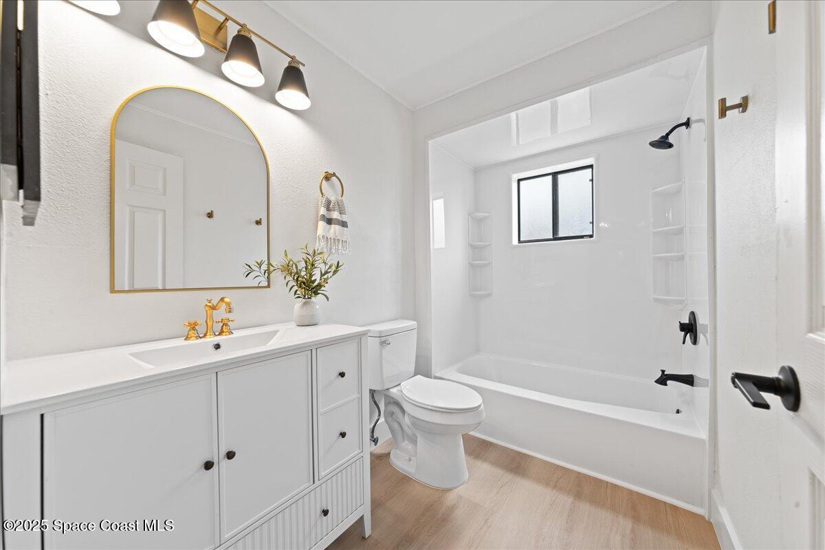 720 Wing Foot Lane Melbourne, FL 32940 - Photo 33 of 45 a bathroom with a sink mirror toilet and bathtub
