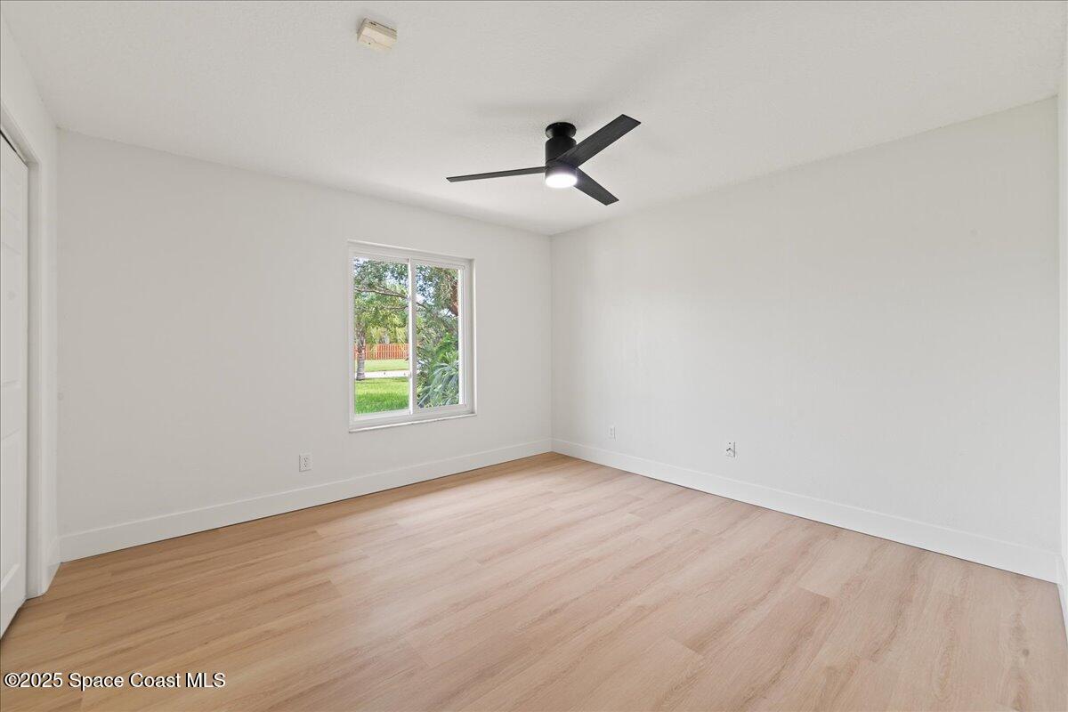 720 Wing Foot Lane Melbourne, FL 32940 - Photo 35 of 45 wooden floor in an empty room with a window