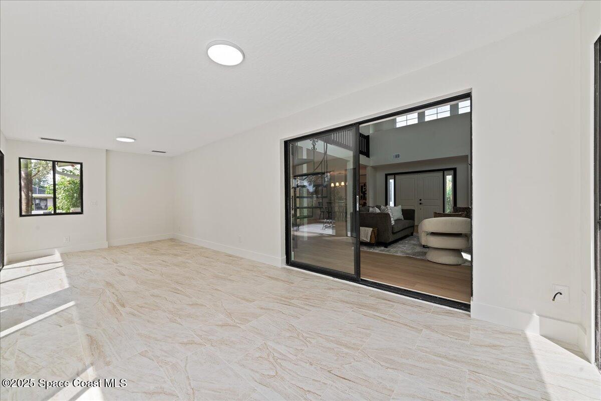720 Wing Foot Lane Melbourne, FL 32940 - Photo 36 of 45 a view of a big room with wooden floor and bedroom