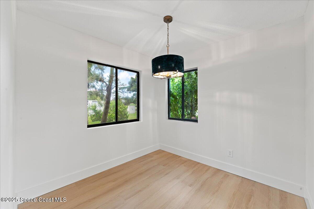 720 Wing Foot Lane Melbourne, FL 32940 - Photo 9 of 45 a room with window and wooden floor