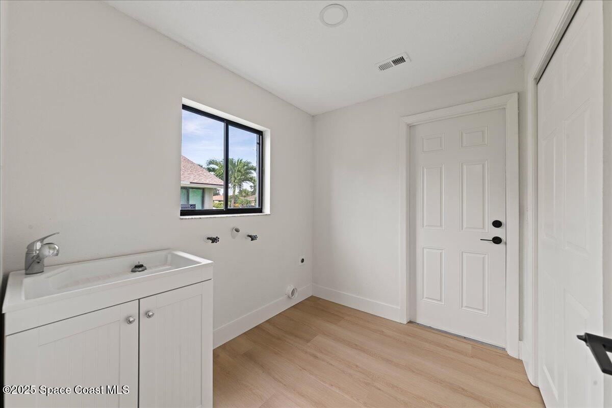 720 Wing Foot Lane Melbourne, FL 32940 - Photo 10 of 45 a view of a bathroom with a sink