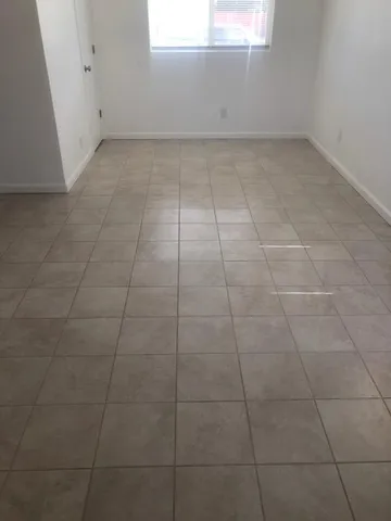 a view of a room with white tiles