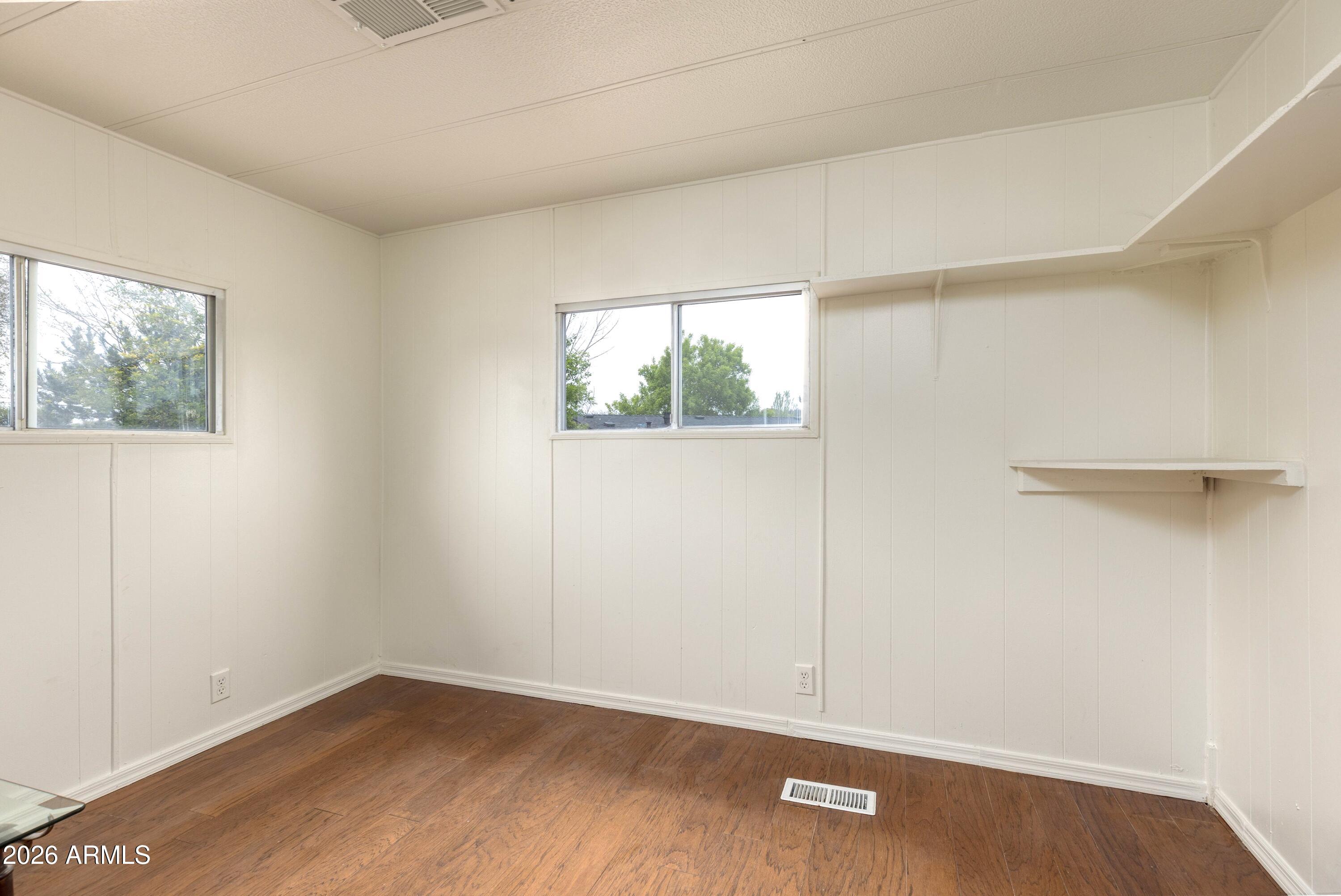 503 West Johnson Drive Payson, AZ 85541 - Photo 10 of 24 an empty room with wooden floor and windows