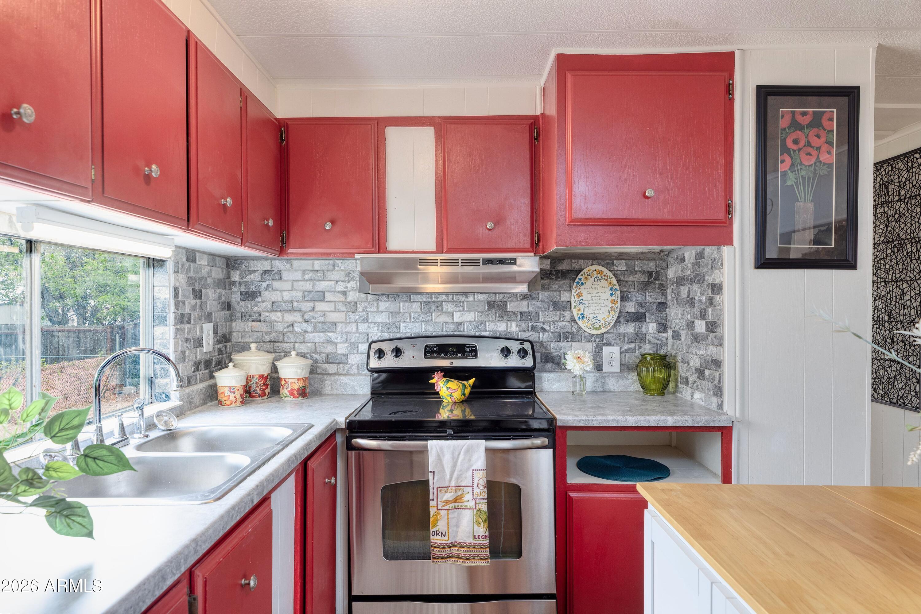 503 West Johnson Drive Payson, AZ 85541 - Photo 9 of 24 a kitchen with stainless steel appliances granite countertop a stove a sink and a microwave