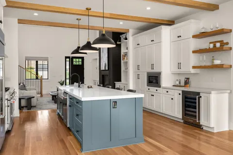 a open kitchen with stainless steel appliances granite countertop a stove and refrigerator