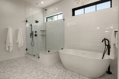 a bathroom with a bathtub and shower