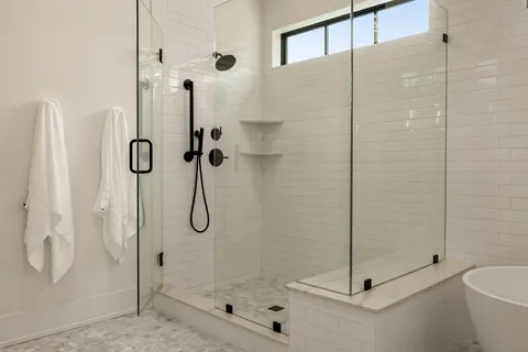 a bathroom with a glass shower door