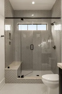 a bathroom with a toilet and a shower