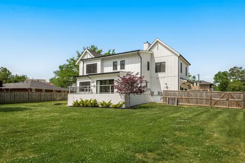 a view of a house with a yard and sitting area