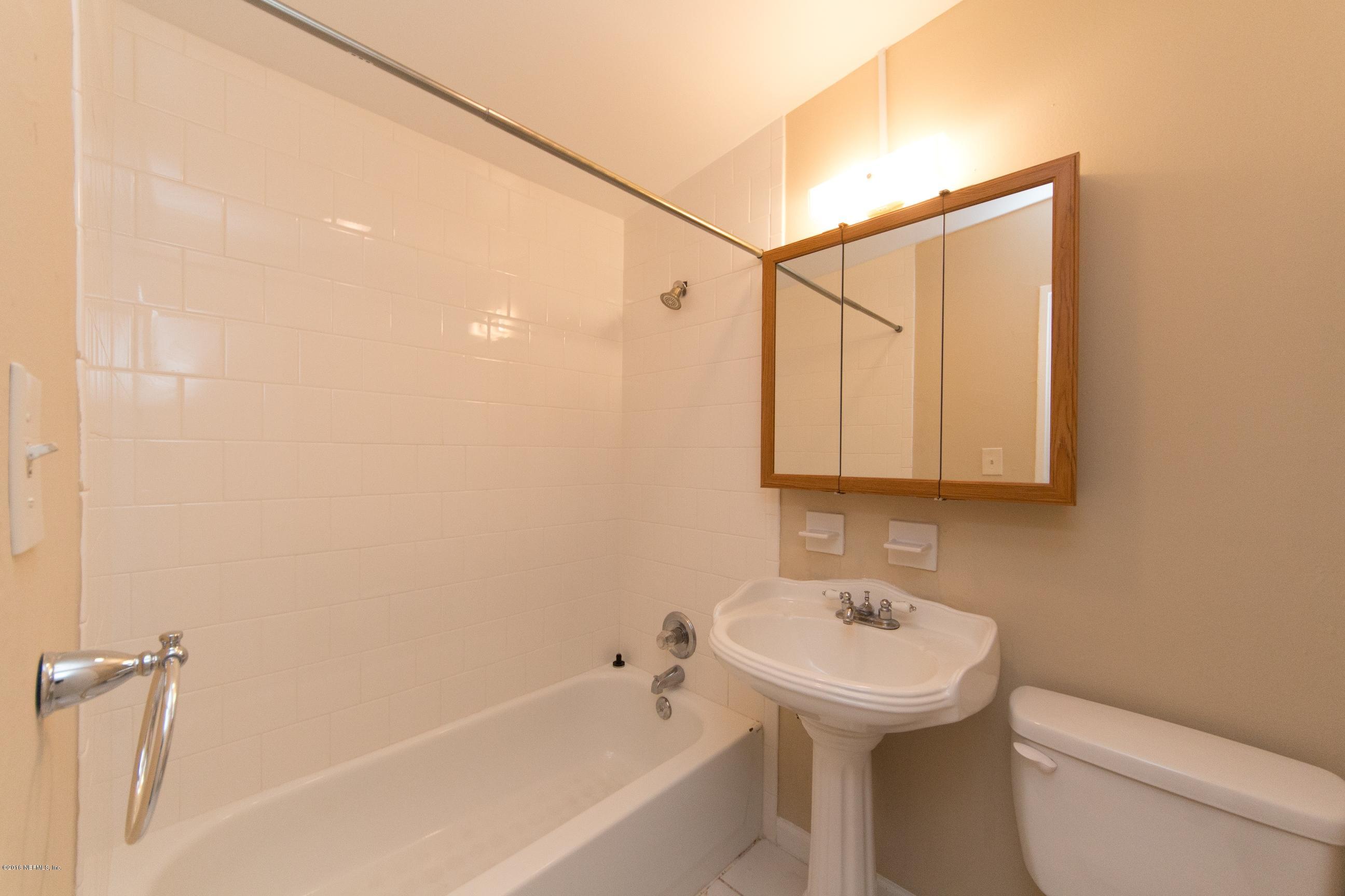 1702 Cortez Road Jacksonville, FL 32246 - Photo 11 of 24 a bathroom with a sink a toilet and shower