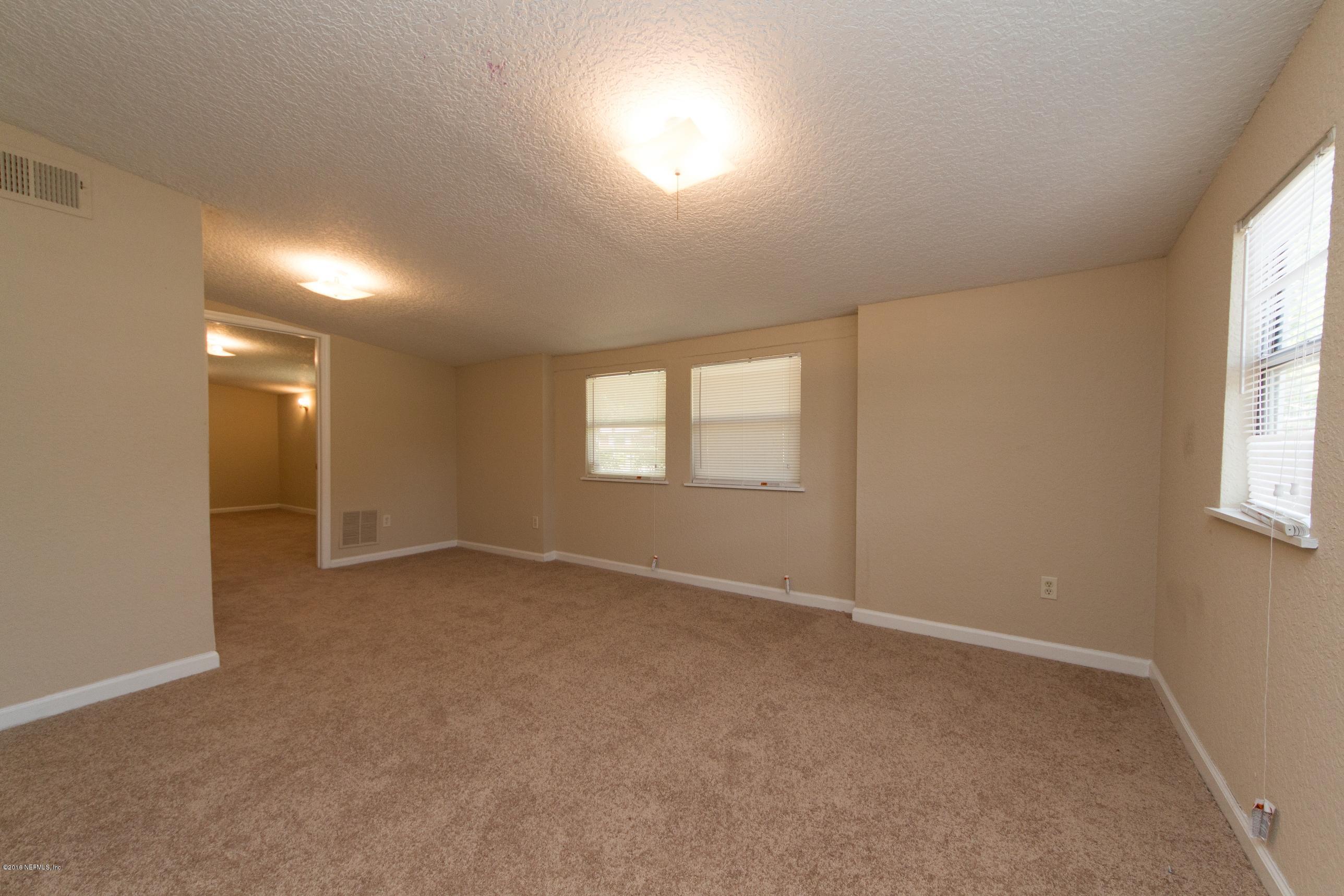 1702 Cortez Road Jacksonville, FL 32246 - Photo 6 of 24 an empty room with windows