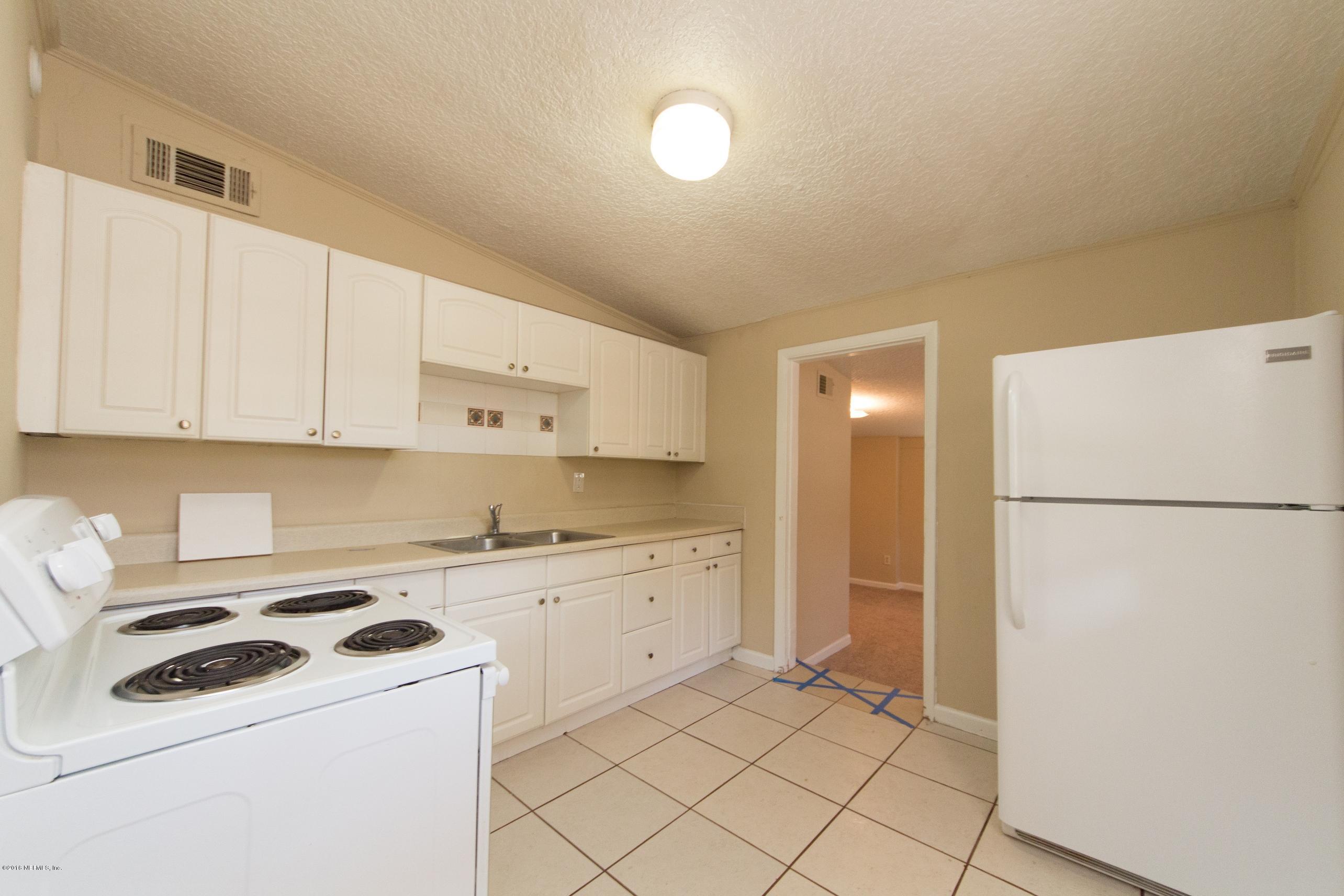 1702 Cortez Road Jacksonville, FL 32246 - Photo 8 of 24 a kitchen with a white cabinets and white appliances
