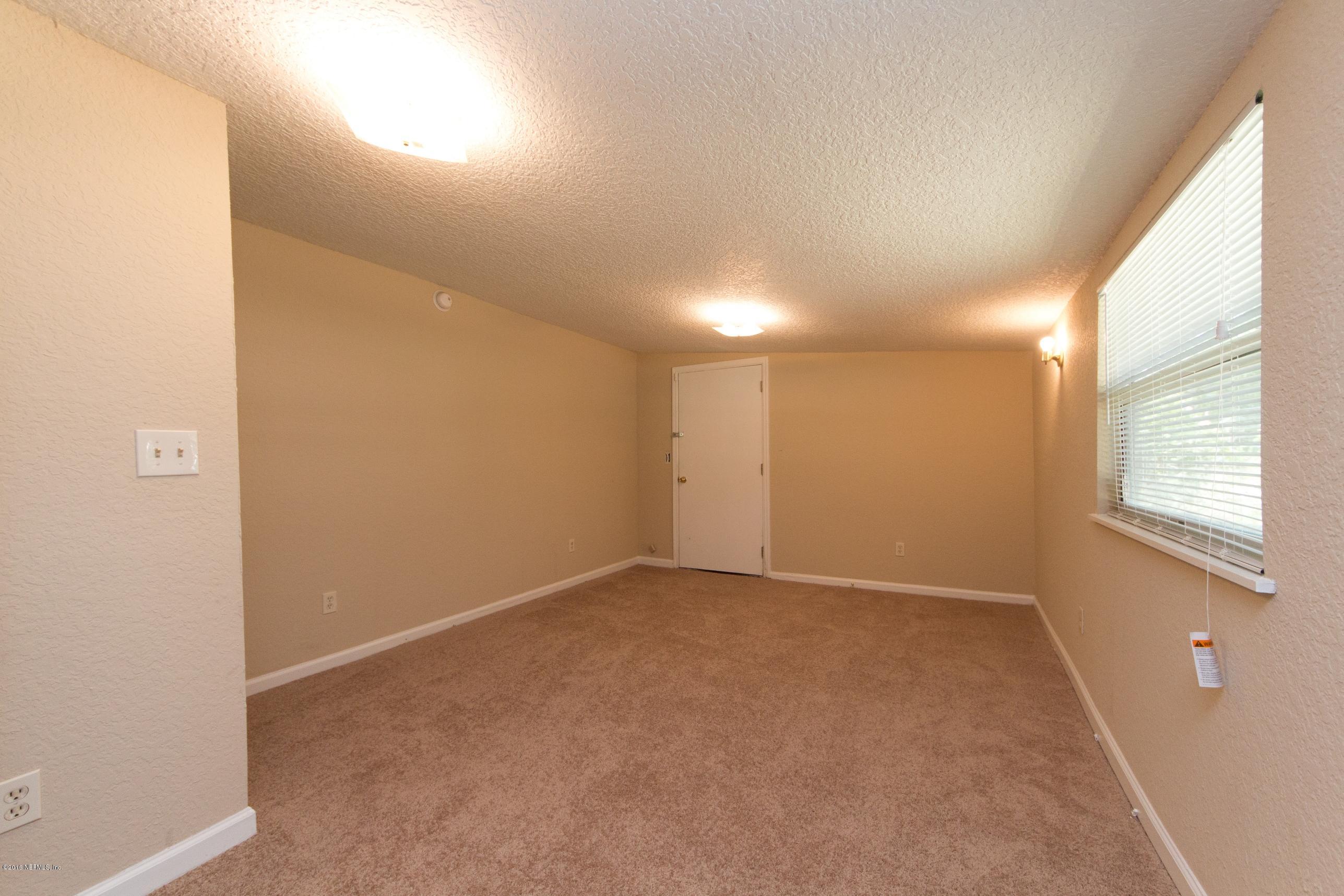 1702 Cortez Road Jacksonville, FL 32246 - Photo 10 of 24 an empty room with windows