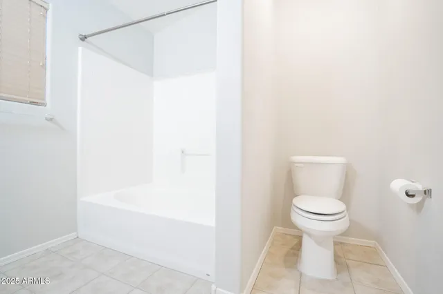 a bedroom with a bed and a chair