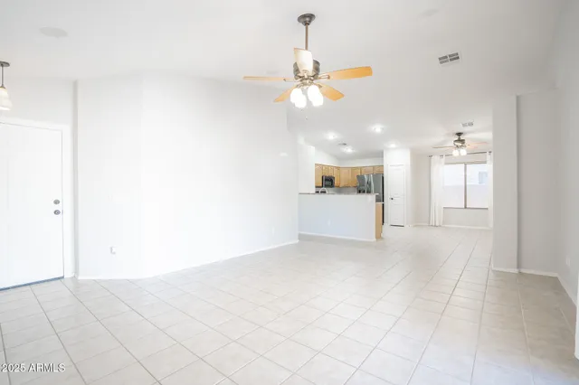 a view of a kitchen with a sink and a chandelier fan