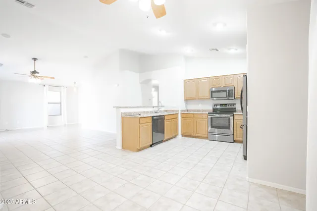 a kitchen with a sink appliances and cabinets