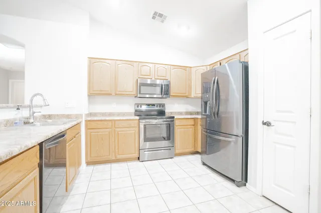 a kitchen with a sink stove and refrigerator
