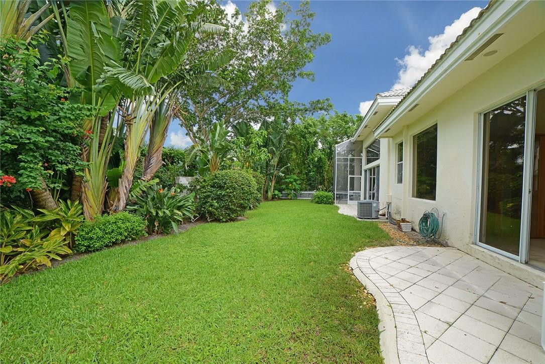 6039 Northwest 32nd Avenue Boca Raton, FL 33496 - Photo 13 of 18 a front view of a house with garden