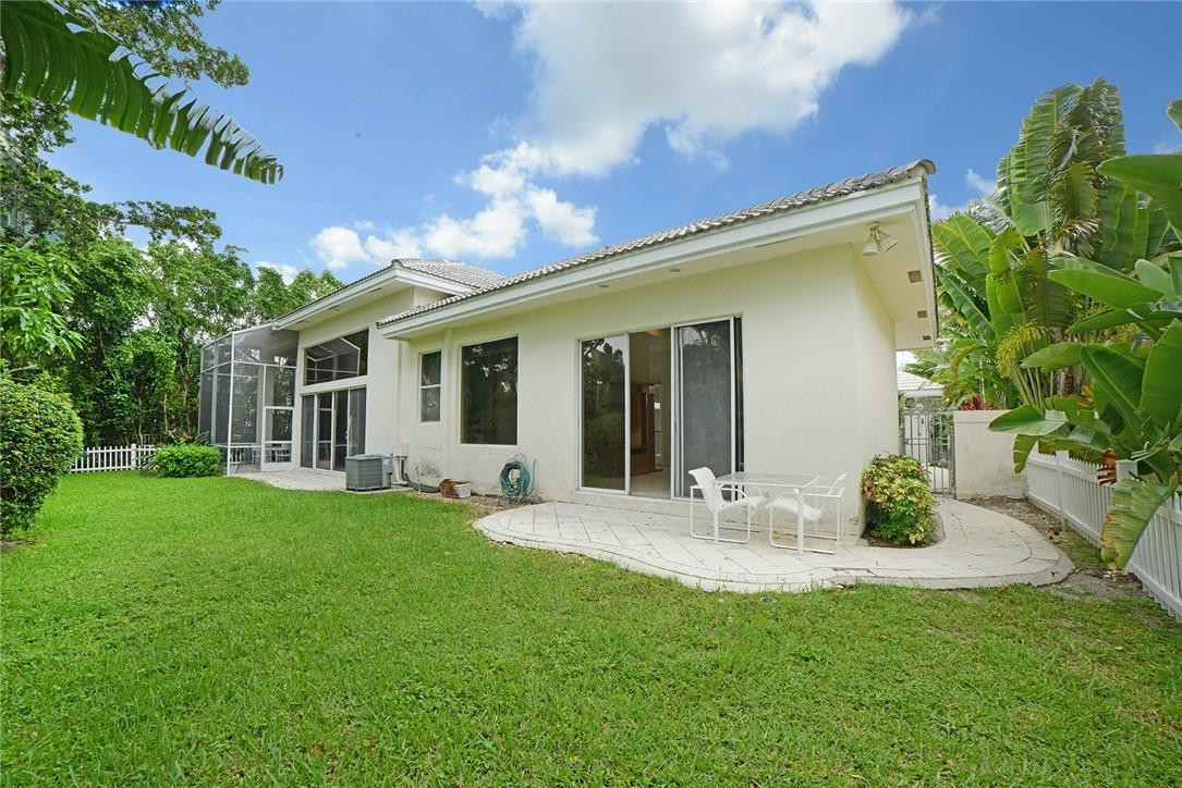 6039 Northwest 32nd Avenue Boca Raton, FL 33496 - Photo 14 of 18 a front view of a house with garden