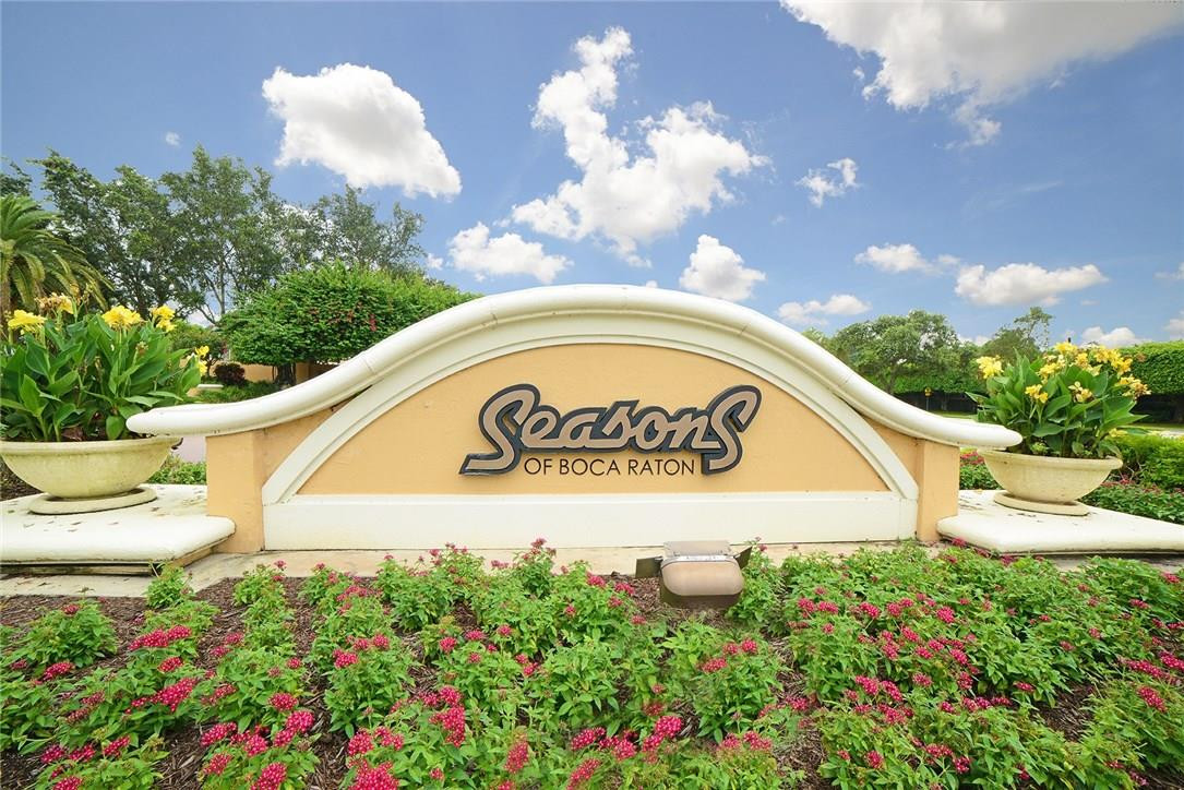6039 Northwest 32nd Avenue Boca Raton, FL 33496 - Photo 18 of 18 a sign that is sitting in front of flowers