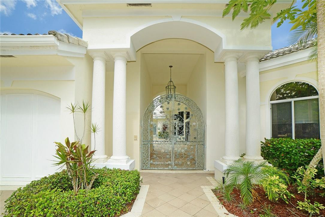 6039 Northwest 32nd Avenue Boca Raton, FL 33496 - Photo 2 of 18 a front view of a house with garden