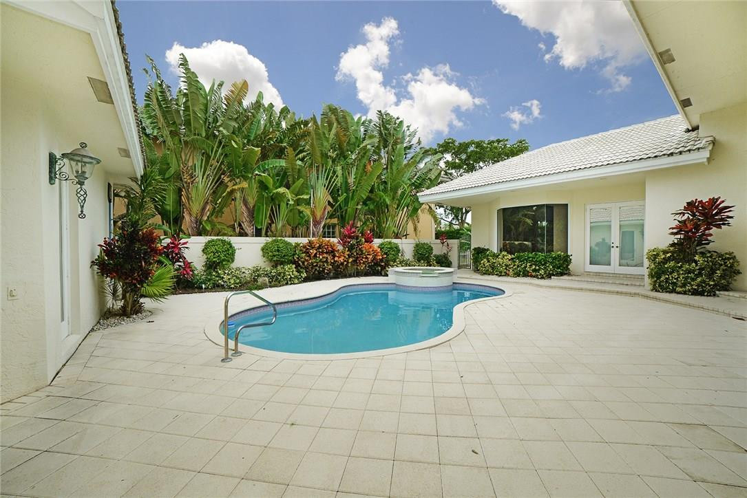 6039 Northwest 32nd Avenue Boca Raton, FL 33496 - Photo 3 of 18 a view of a backyard with plants and a patio