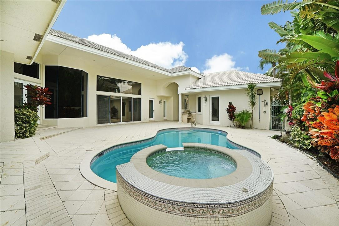6039 Northwest 32nd Avenue Boca Raton, FL 33496 - Photo 4 of 18 a view of a house with roof fire pit next to a yard