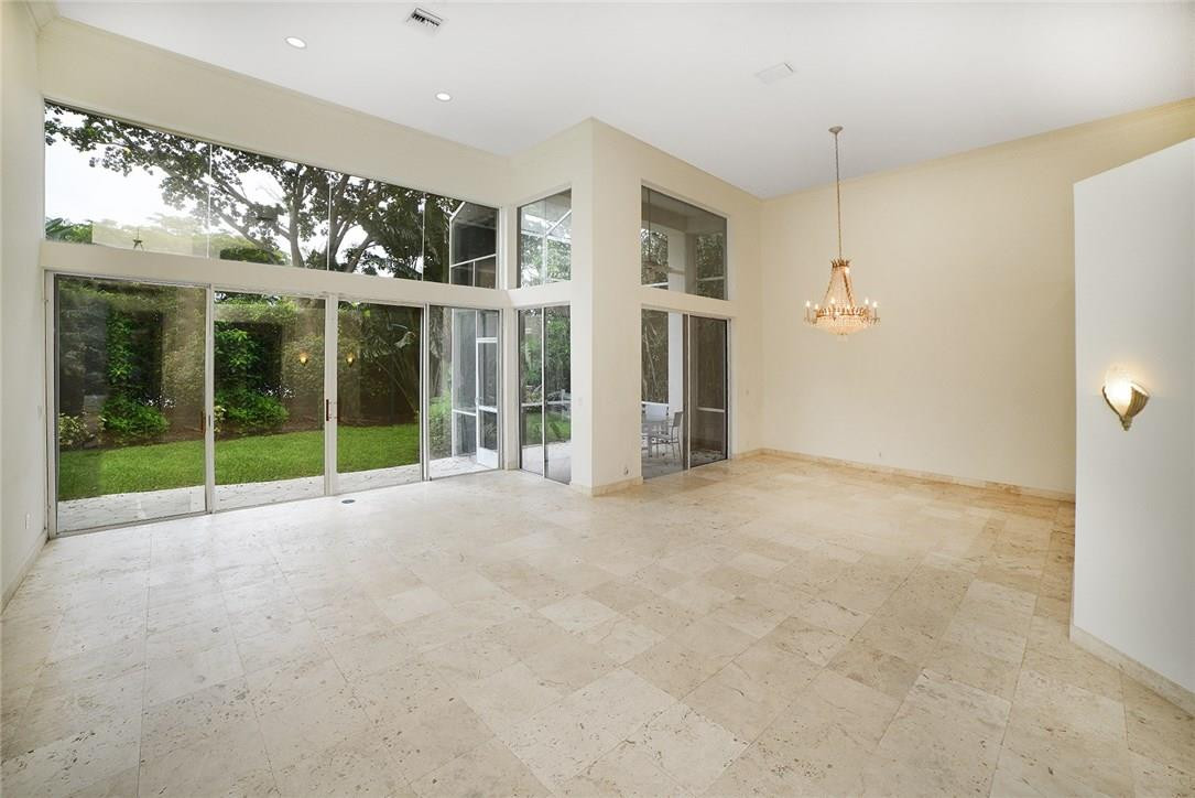6039 Northwest 32nd Avenue Boca Raton, FL 33496 - Photo 6 of 18 a view of an empty room with a windows and chandelier