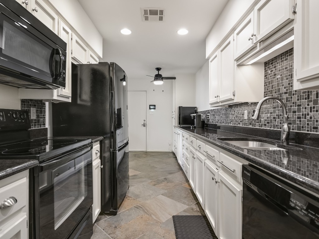 8314 Bent Tree Road Austin, TX 78759 - Photo 7 of 15 Kitchen featuring black appliances, decorative backsplash, dark stone countertops, white cabinetry, and recessed lighting