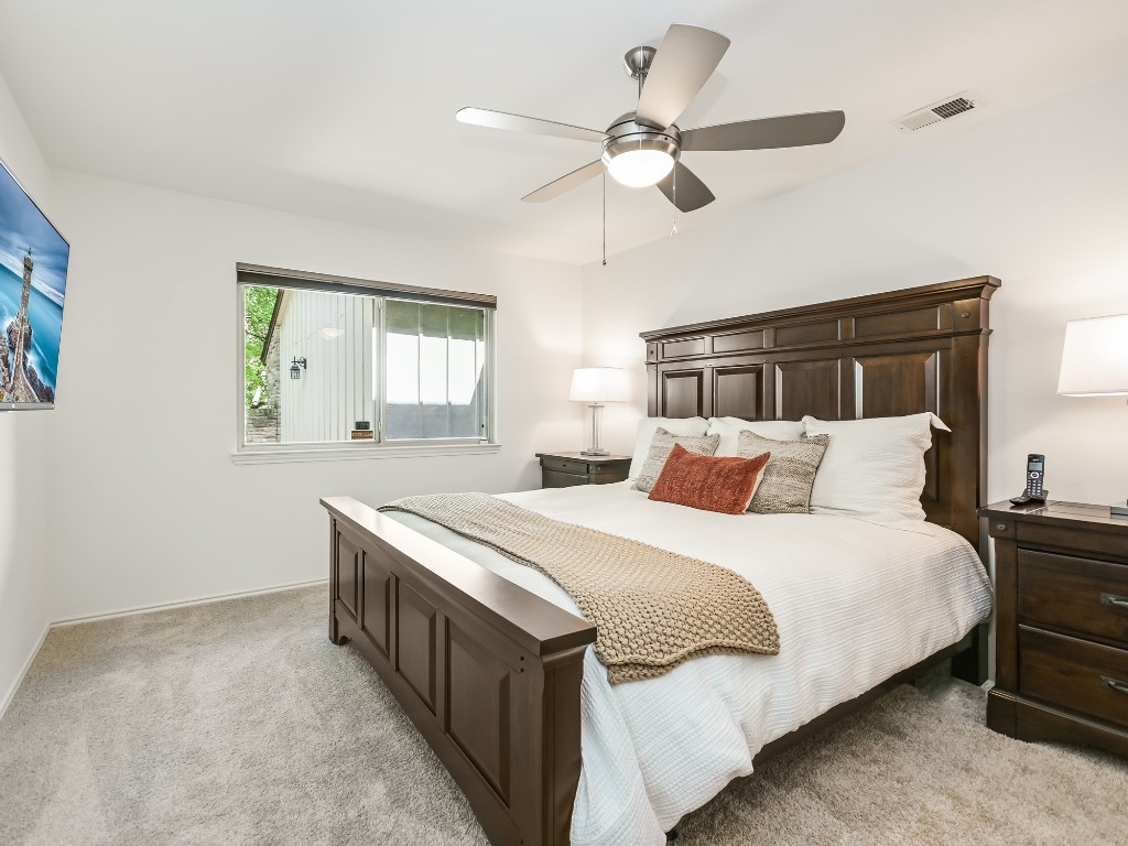 8314 Bent Tree Road Austin, TX 78759 - Photo 9 of 15 Bedroom featuring light colored carpet and ceiling fan