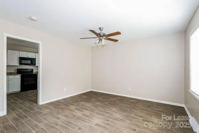 a view of a room with a ceiling fan and a rug