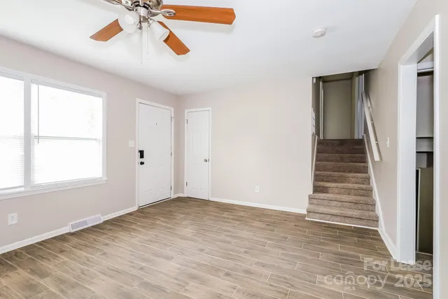 wooden floor in an empty room with a window