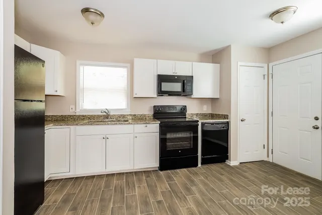 a kitchen with granite countertop a stove and a sink
