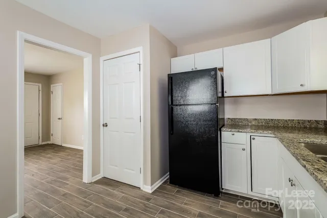 a kitchen with a refrigerator and cabinets